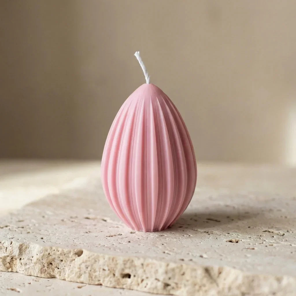 Sculptural fluted egg candle styled beautifully as a modern minimalist accent on a pastel spring Easter tablescape.