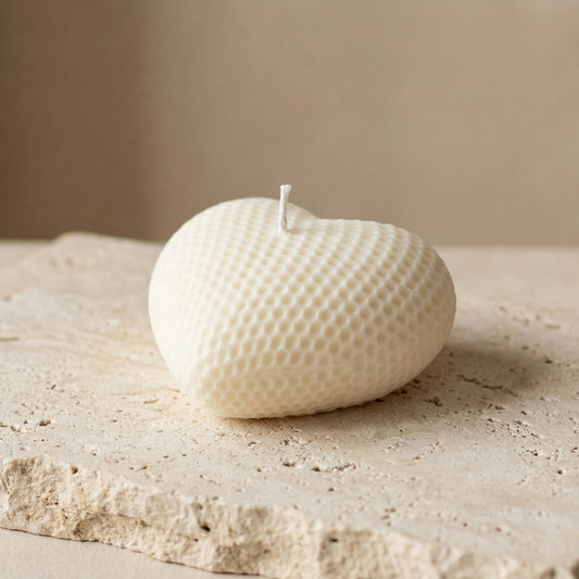 Honeycomb heart candle styled beautifully as a cozy, textured romantic accent on a modern nightstand.
