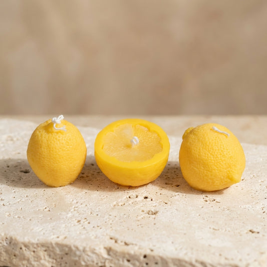 Lemon candle trio styled beautifully as a vibrant, summery Mediterranean centerpiece on a fresh kitchen counter.