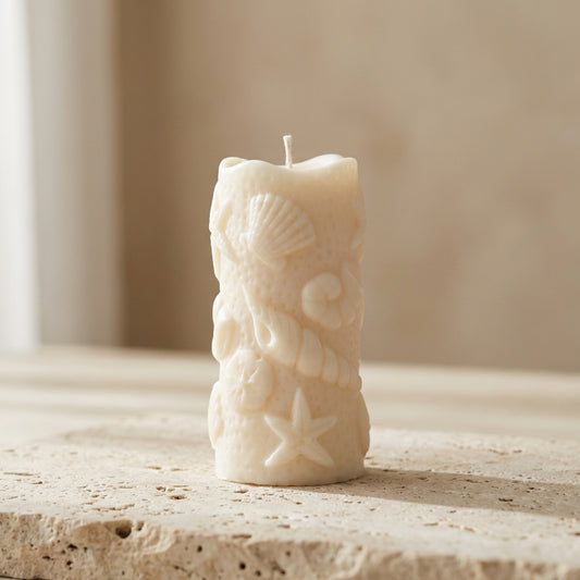 Ocean shell pillar candle styled beautifully as an elegant, serene coastal accent in a relaxing bathroom setup.
