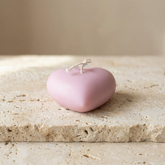 Smooth heart candle styled beautifully as a calm, romantic aesthetic accent on a modern coffee table.