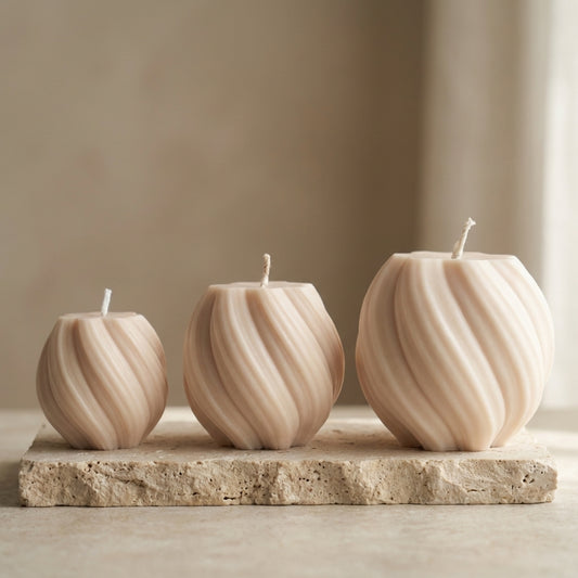 Close-up of a hand-poured soy wax swirl globe trio set highlighting their continuous ribbed lines and three varying sizes.