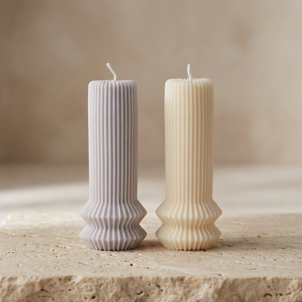 Architectural fluted pillar candle styled as a modern minimalist accent on a beautifully curated coffee table display.