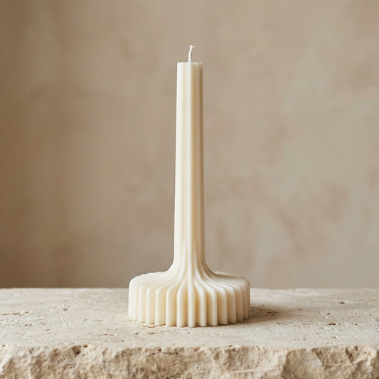 Architectural ribbed column candle styled beautifully as a modern minimalist statement piece on an elegant fireplace mantle.