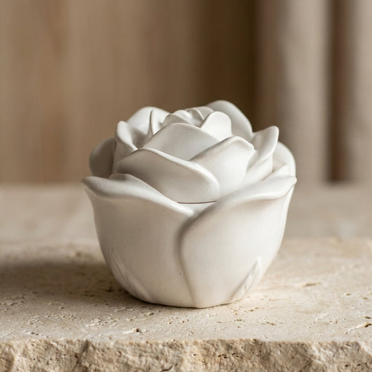 Close-up of a meticulously sculpted gypsum rose jar and matching lid, featuring hand-poured natural soy wax inside.