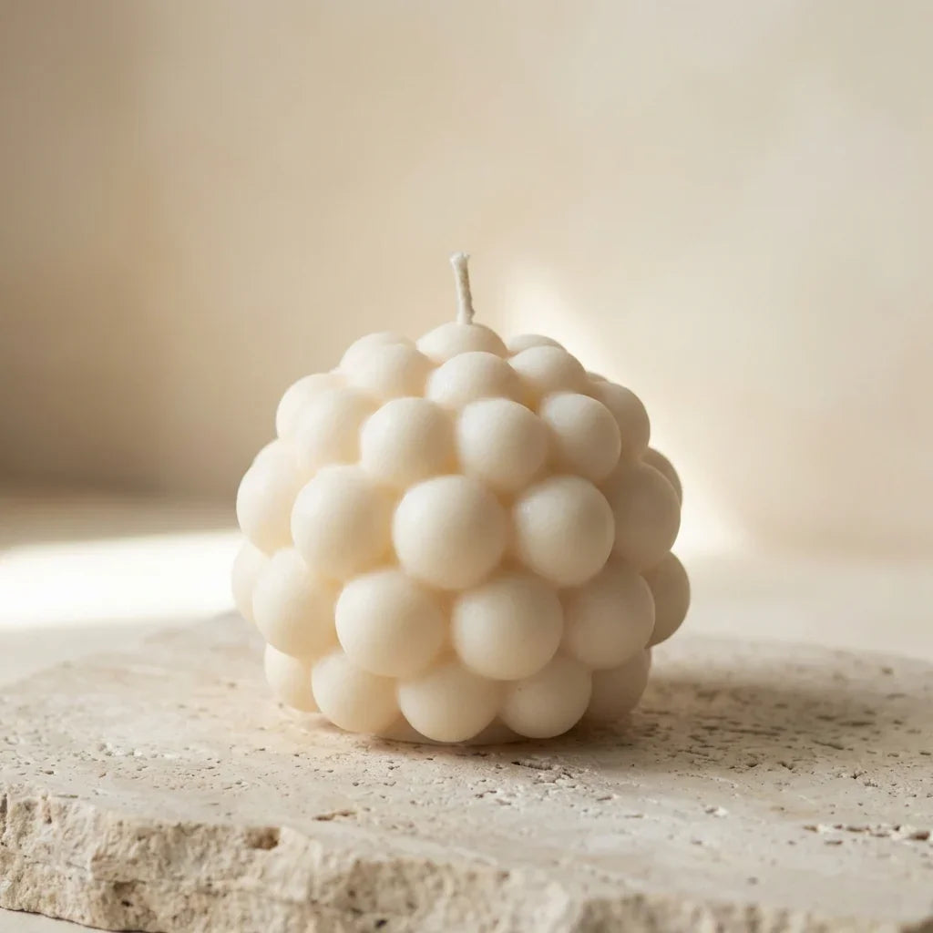 Close-up of a hand-poured soy wax bubble sphere candle highlighting its textured, geometric design.