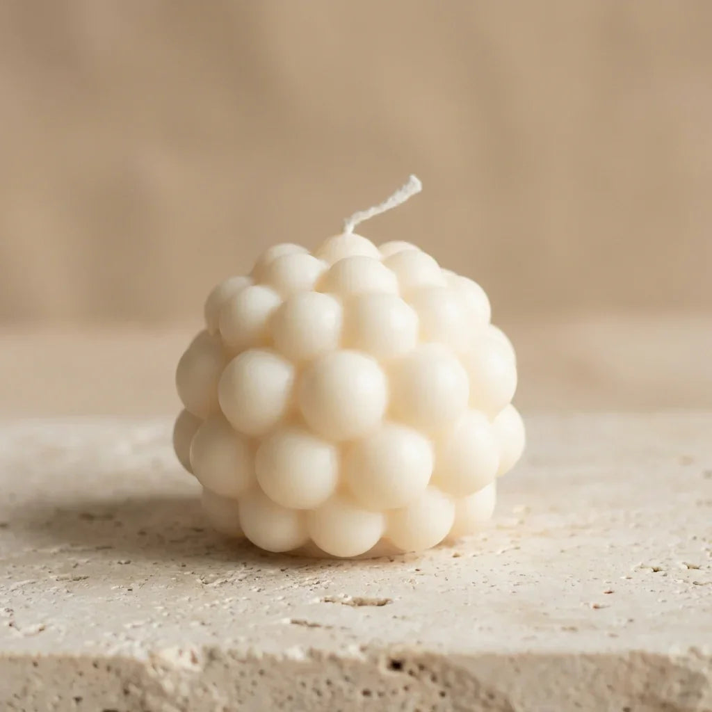 Close-up of a hand-poured soy wax bubble sphere candle highlighting its textured, geometric design.
