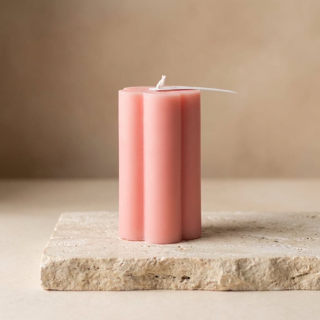 Close-up of a hand-poured soy wax daisy pillar candle highlighting its soft, petal-like edges.