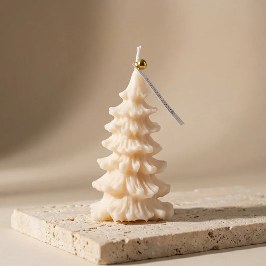 Tree-shaped candle on a stone surface with a neutral background