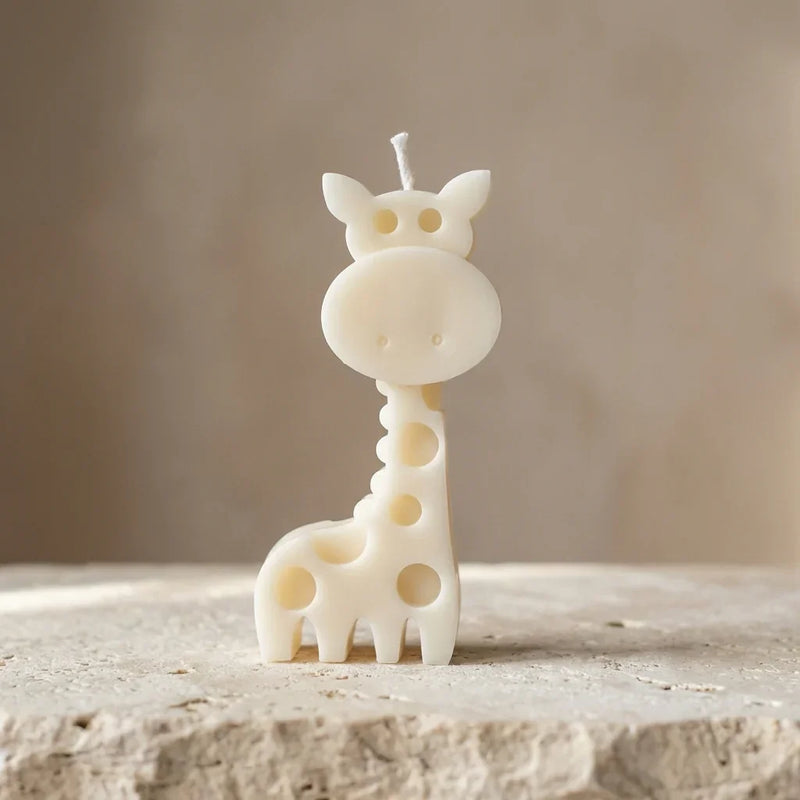 Close-up of a hand-poured soy wax giraffe candle showing decorative spot cut-out details.