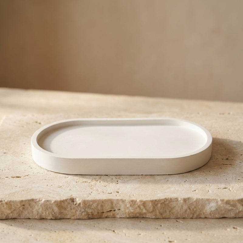 Close-up of a handcrafted oval candle tray highlighting its sleek, minimalist gypsum silhouette and smooth varnished finish.