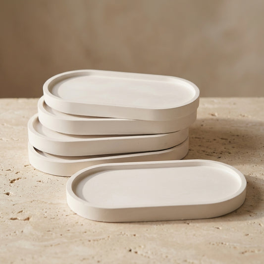 Handcrafted oval candle tray styled beautifully as a protective, aesthetic base for a sculptural candle on a modern entryway console.