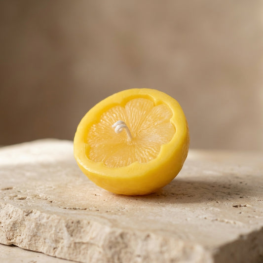 Close-up of a hand-poured soy wax lemon half candle highlighting its incredibly lifelike, realistic citrus wedge texture.