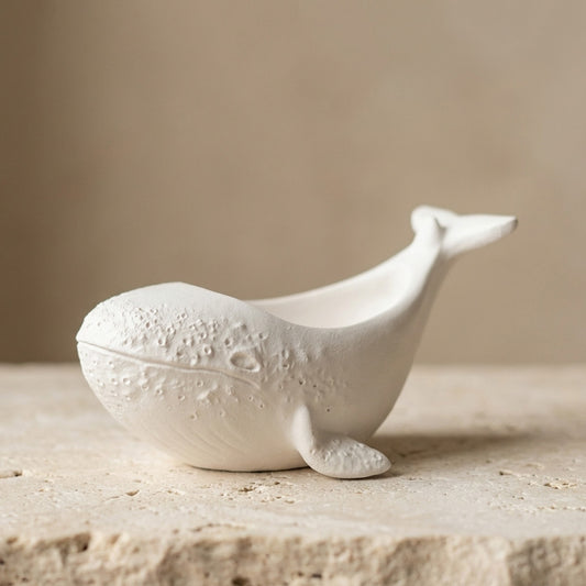 Close-up of a handcrafted classic matte white gypsum little whale vessel highlighting its smooth, double-varnished protective finish.