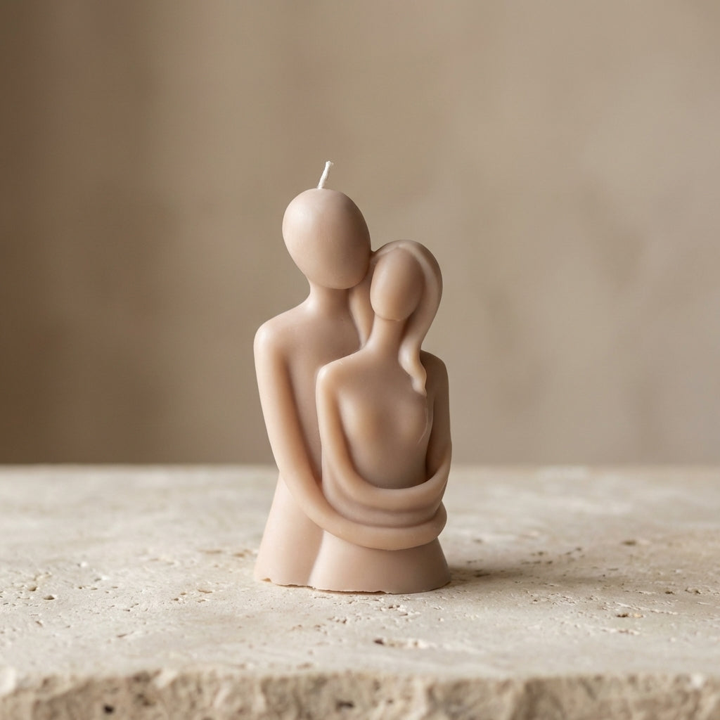 Close-up of a hand-poured soy wax lovers sculpture candle highlighting its smooth, minimalist abstract design of a couple embracing.