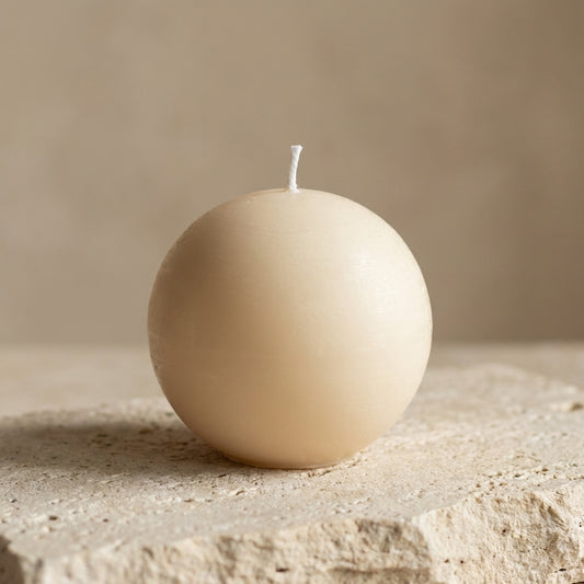 Close-up of a hand-poured soy wax minimalist sphere candle highlighting its flawless, smooth globe silhouette.