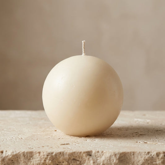 Minimalist sphere candle styled beautifully as a modern, grounded geometric centerpiece on a curated coffee table display.
