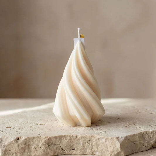 Close-up of a hand-poured soy wax modern swirl Christmas tree candle highlighting its elegant, continuous twisted lines.