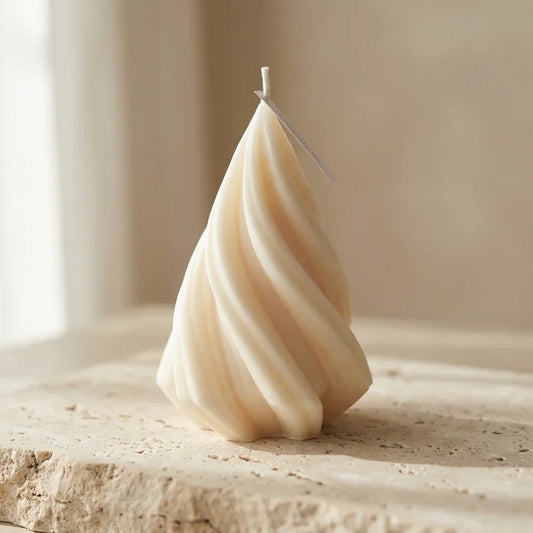 Close-up of a hand-poured soy wax modern swirl Christmas tree candle highlighting its elegant, continuous twisted lines.