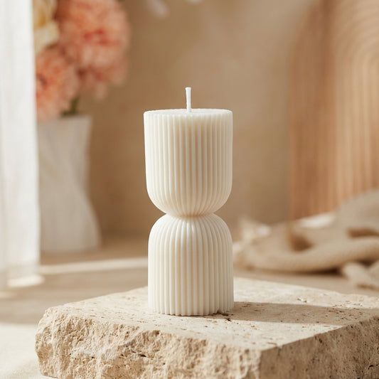 Close-up of a hand-poured soy wax petite ribbed hourglass candle highlighting its deeply fluted texture and pinched center.