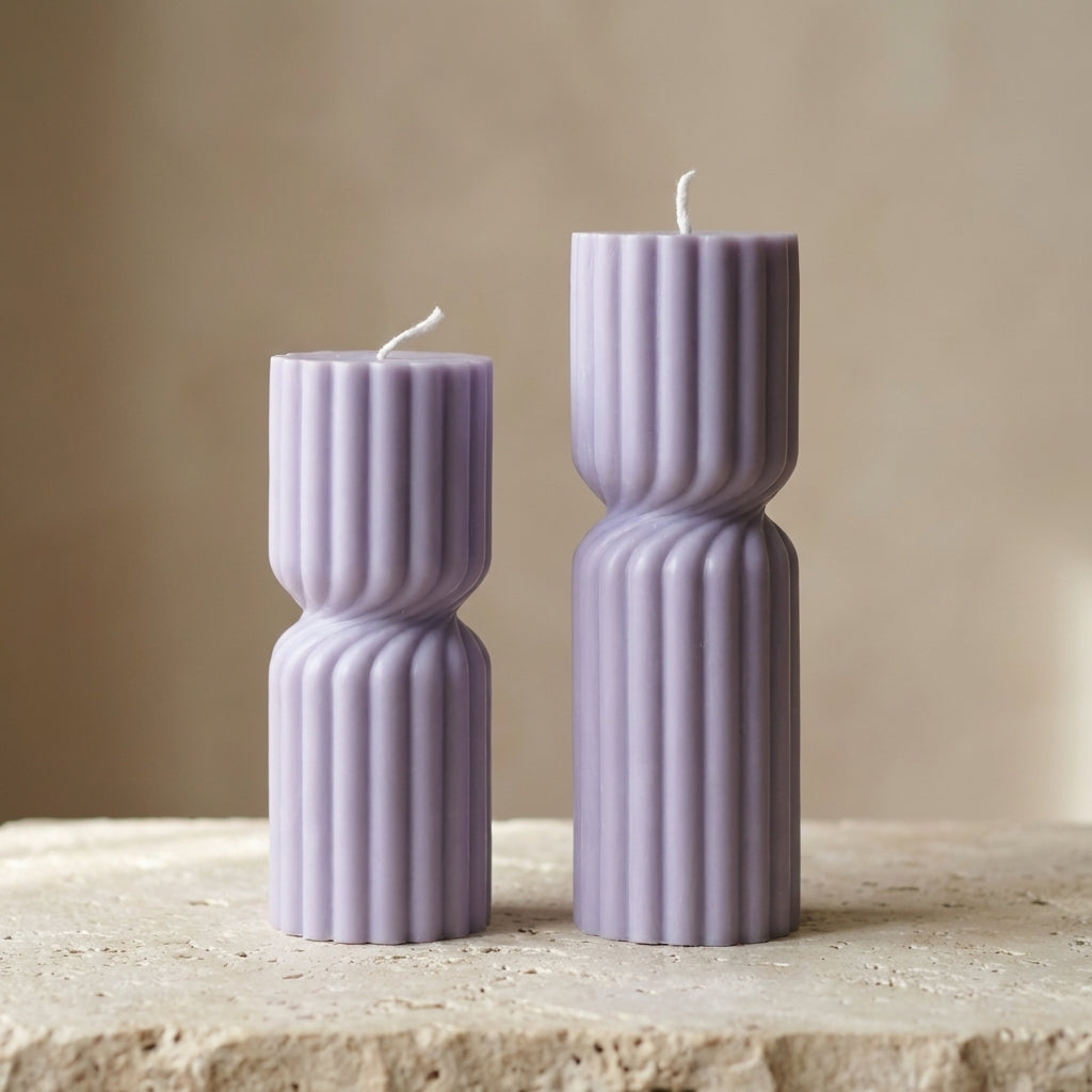 Ribbed hourglass pillar duo styled beautifully as a modern architectural, multi-level display on an elegant console table.