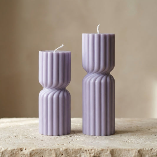 Ribbed hourglass pillar duo styled beautifully as a modern architectural, multi-level display on an elegant console table.