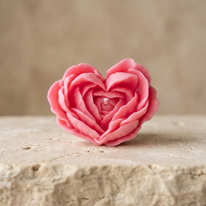 Close-up of a hand-poured soy wax floral rose heart candle highlighting its perfect heart shape formed by delicate, overlapping flower petals.