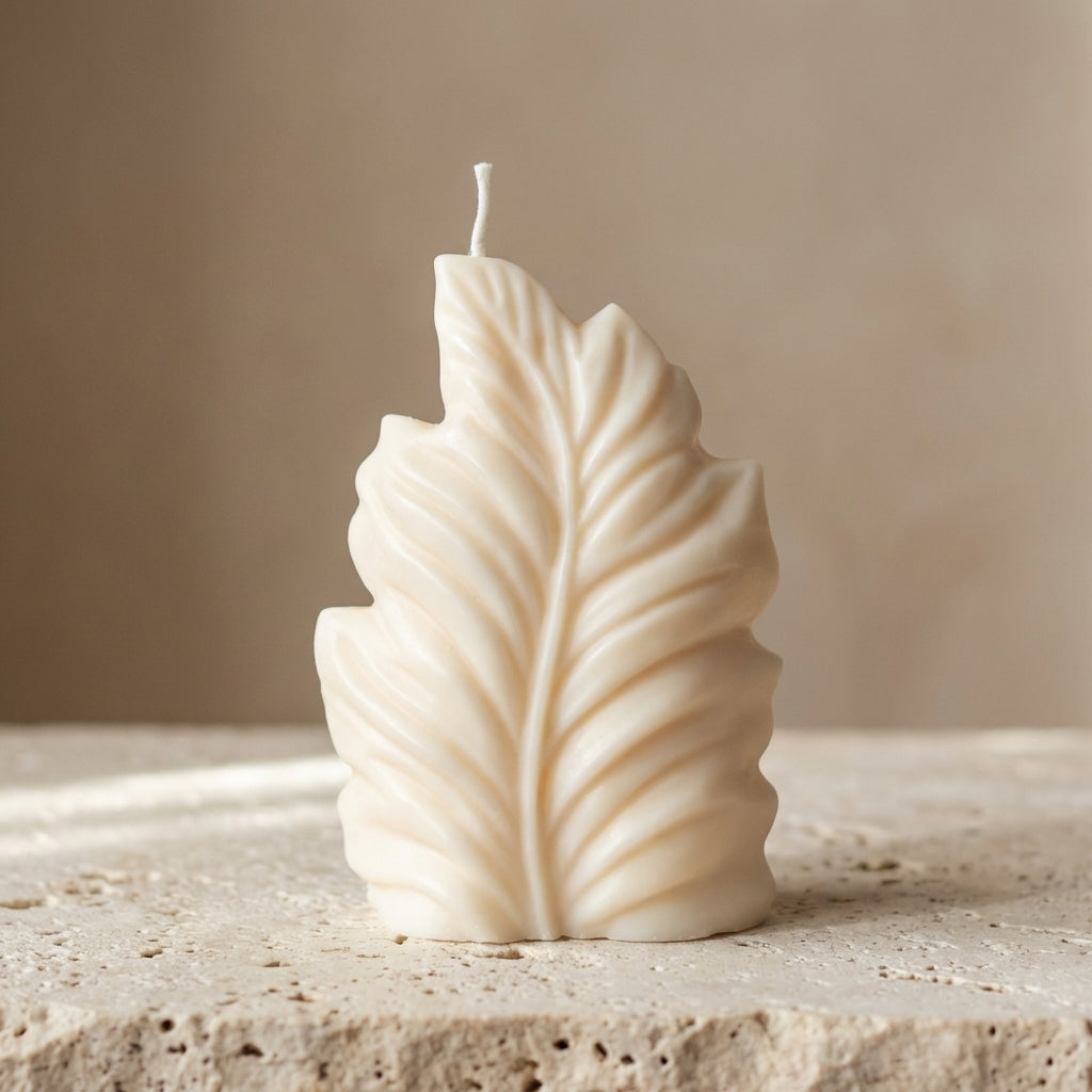 Close-up of a hand-poured soy wax sculptural botanical leaf candle highlighting its beautifully embossed veins and organic silhouette.