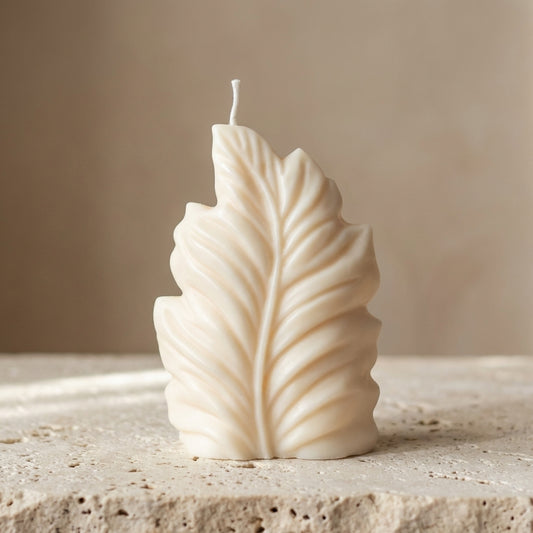 Close-up of a hand-poured soy wax sculptural botanical leaf candle highlighting its beautifully embossed veins and organic silhouette.