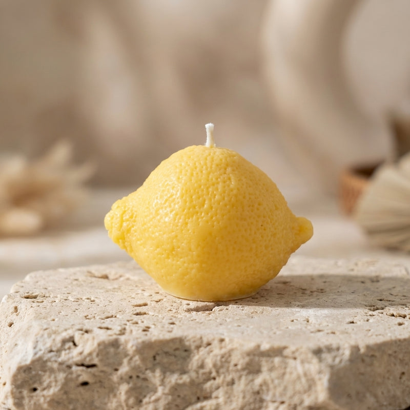 Close-up of a hand-poured soy wax classic lemon candle highlighting its incredibly realistic, dimpled peel texture.