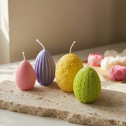 Set of four sculptural spring egg candles styled beautifully together as a breathtaking, elegant Easter tablescape centerpiece.