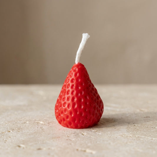 Strawberry cake candles styled playfully as unique, vibrant toppers on a beautiful birthday cake.