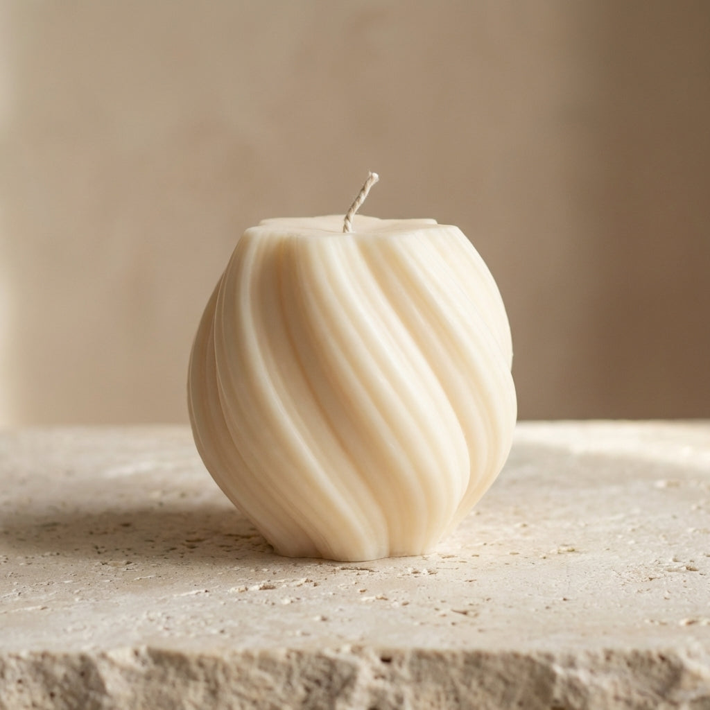 Close-up of a hand-poured soy wax swirl globe candle highlighting its continuous ribbed lines and twisted organic silhouette.