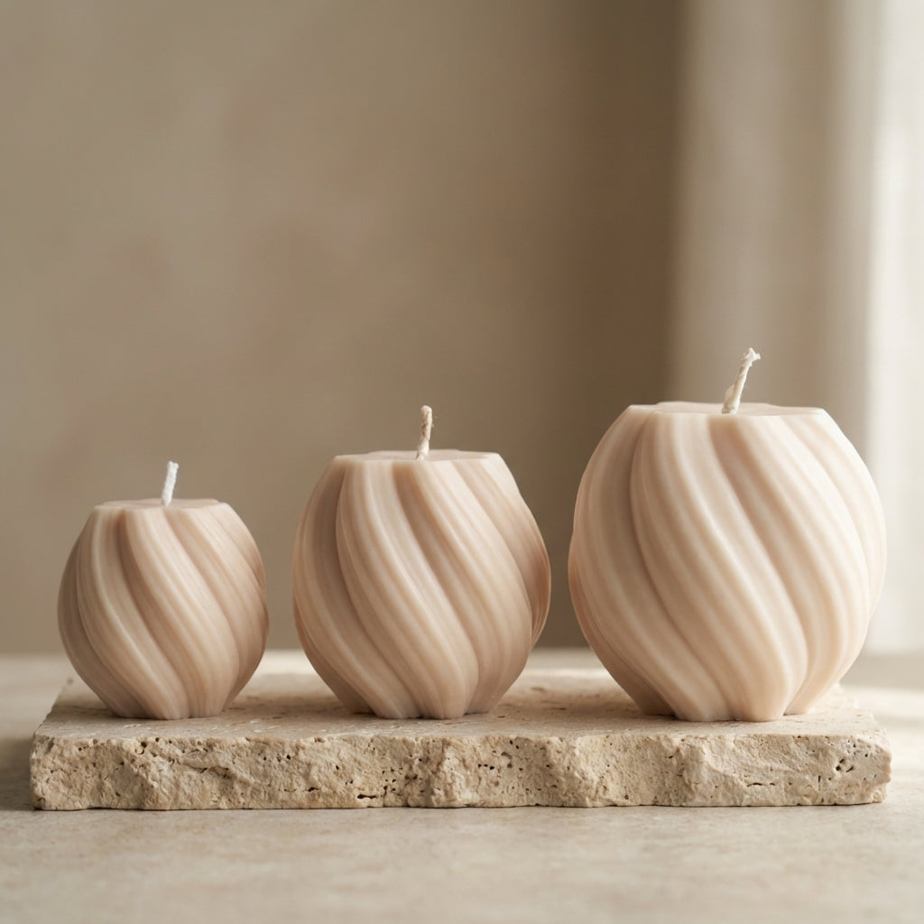 Close-up of a hand-poured soy wax swirl globe trio set highlighting their continuous ribbed lines and three varying sizes.