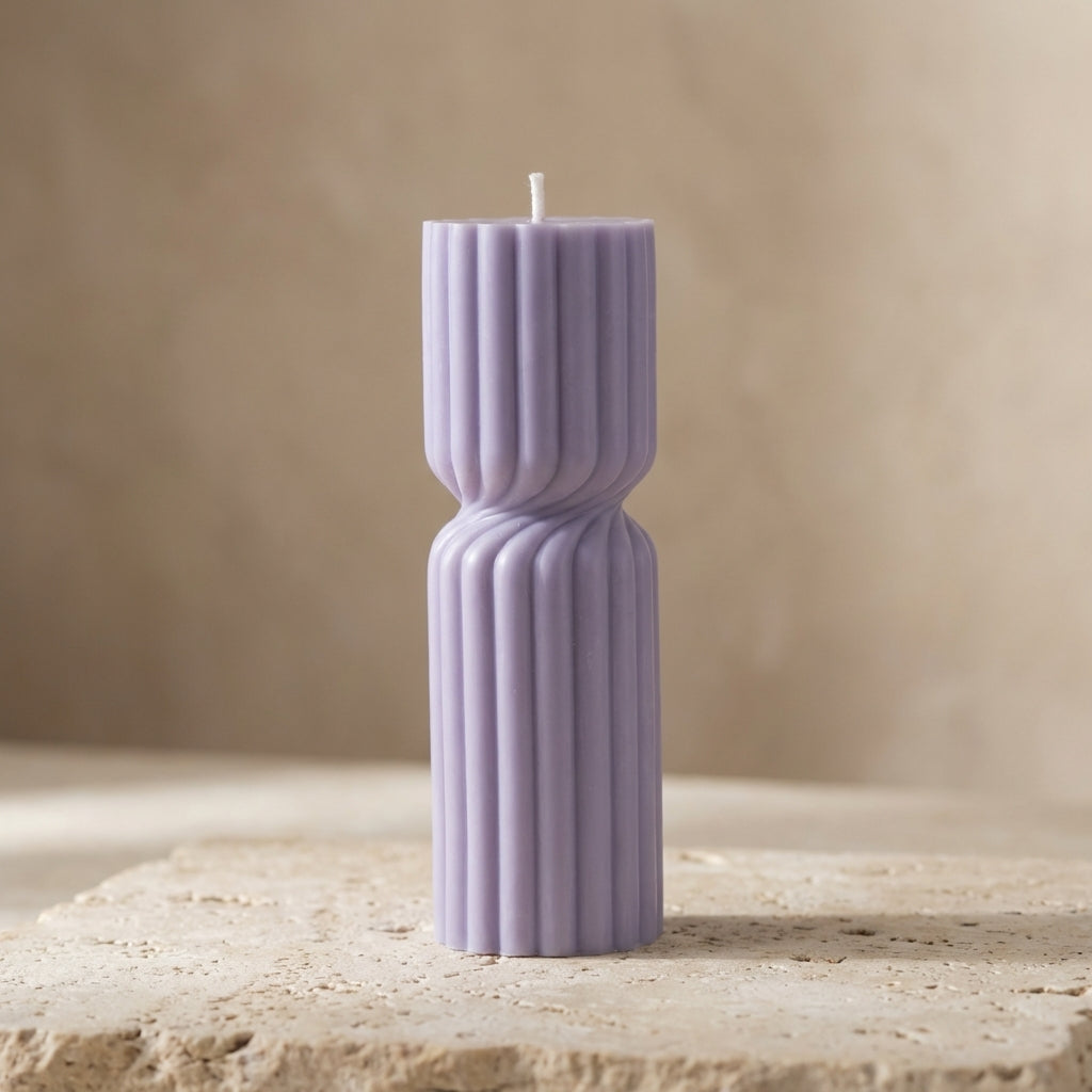Tall ribbed hourglass pillar candle styled beautifully as a modern architectural statement piece on an elegant display tray.
