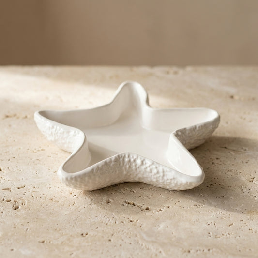 Close-up of a handcrafted textured starfish trinket dish highlighting its realistic bumpy exterior and smooth, scooped interior basin.