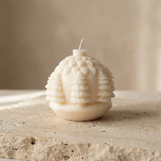 Textured candle on a stone surface with a neutral background